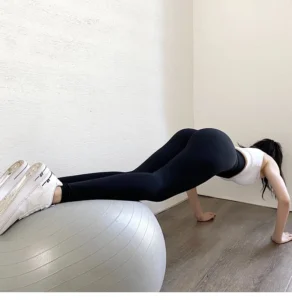 woman in black leggings plank